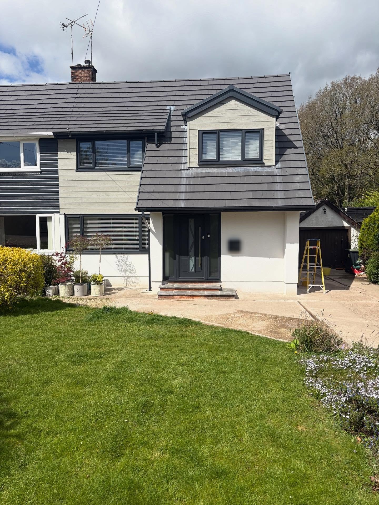 Semi-detached house rendered white, front garden