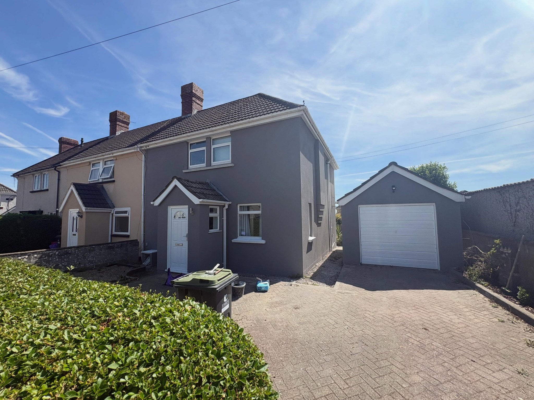 Semi-detached house and garage after a full hack off and grey silicone render
