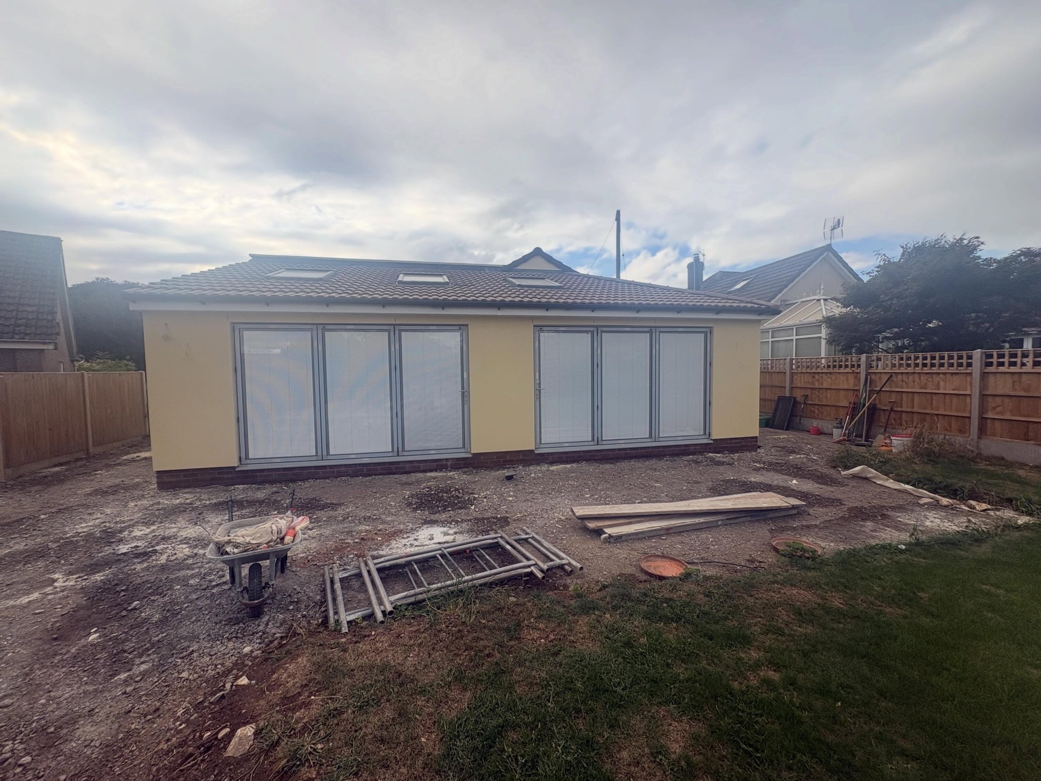 Rear extension with bifold doors, rendered in pale yellow