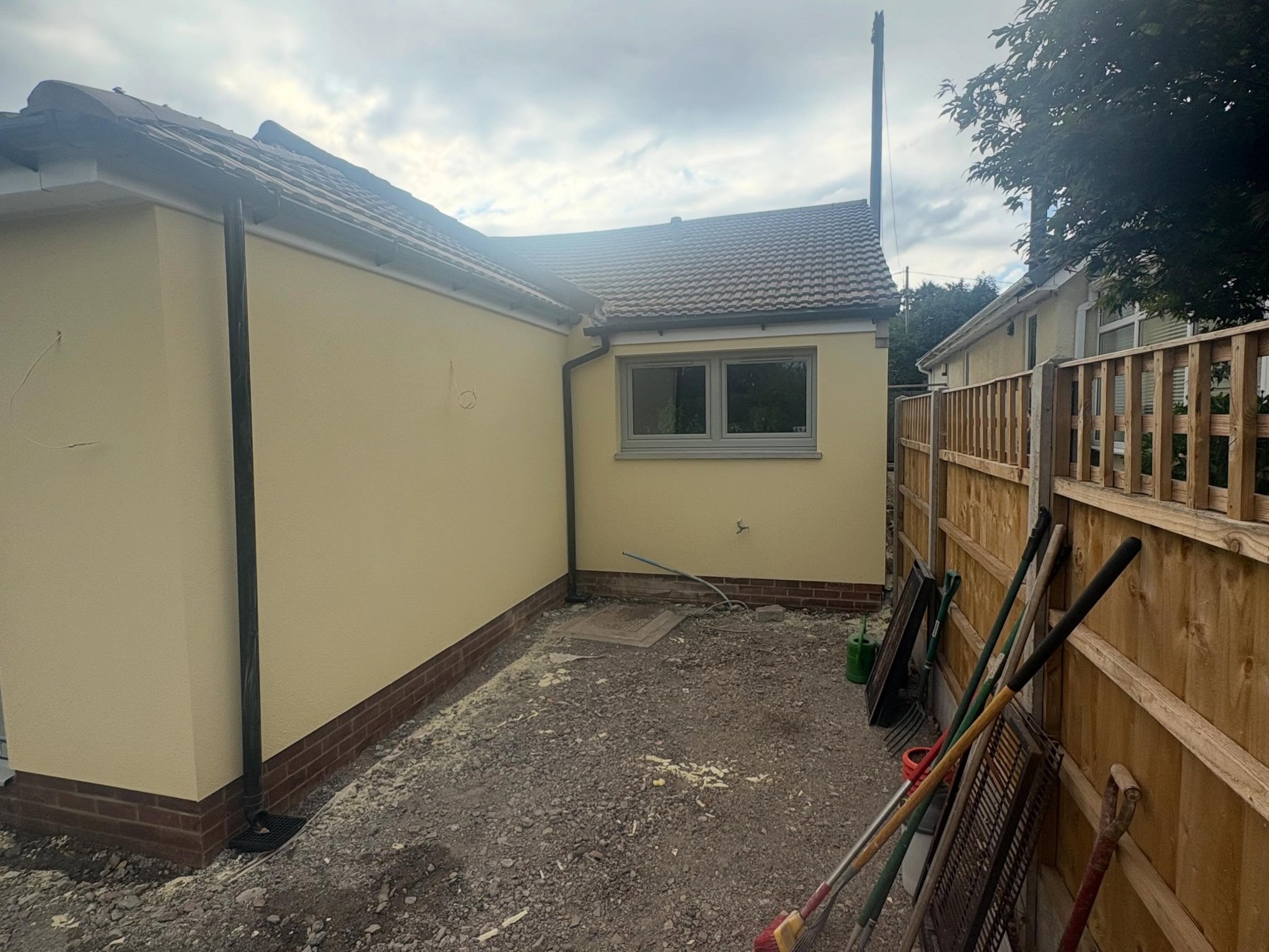 Rear corner of the bungalow in pale yellow render
