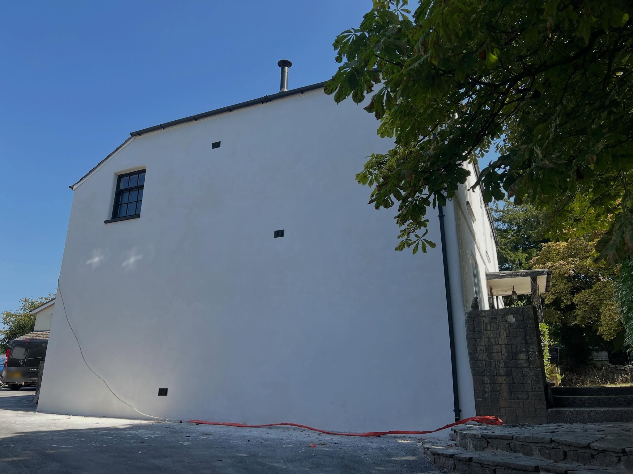 Tall gable finished in white lime render