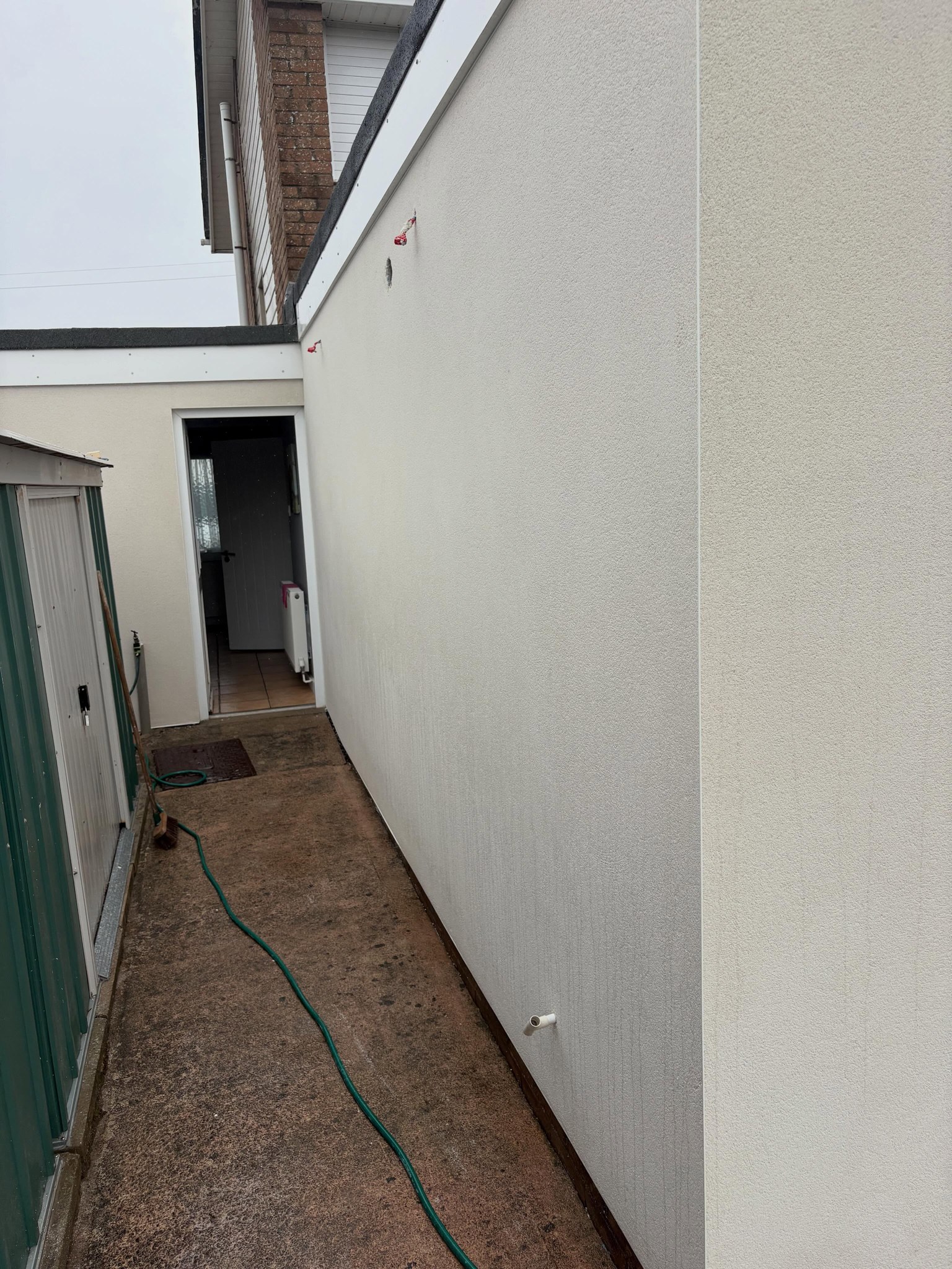 Side passage with the newly rendered wall