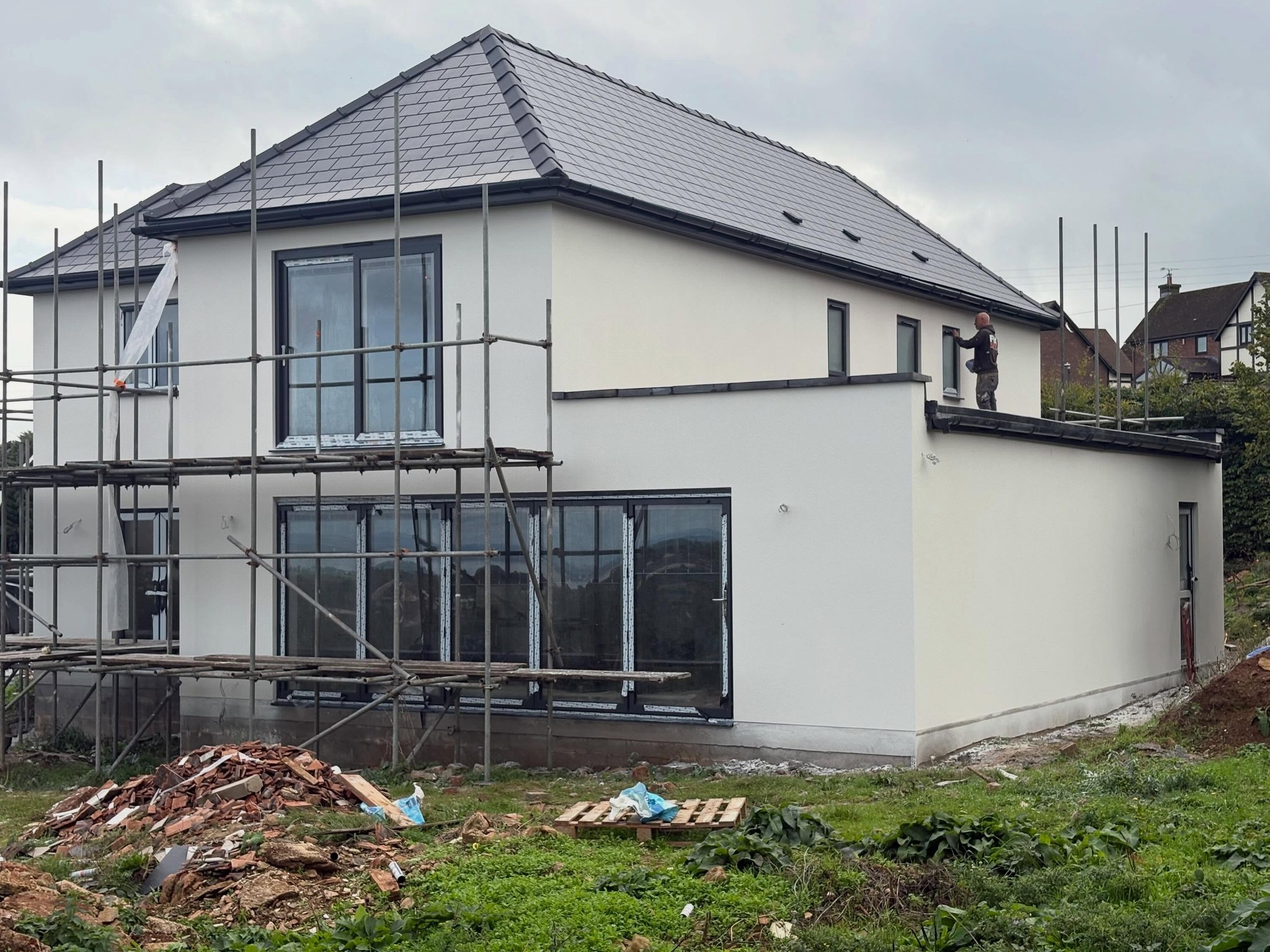 Two storey house being rendered under scaffolding