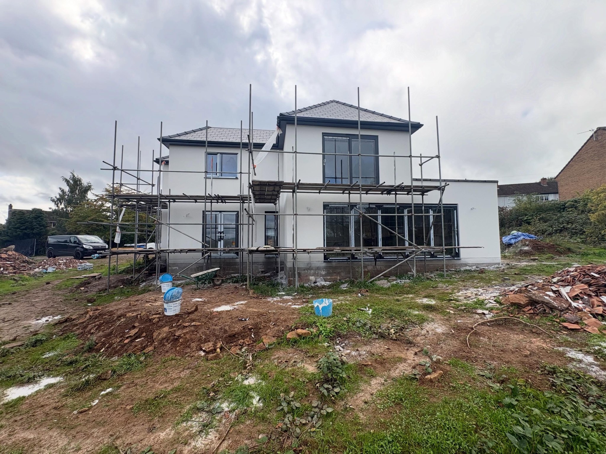 Whole house in white render with scaffolding still up