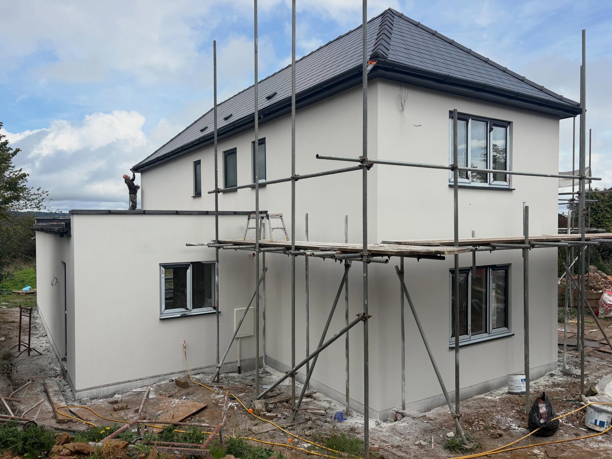 Side of the house and single storey wing in fresh white render